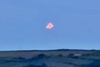 Mysterious multicoloured UFO stuns witness in Cornwall - filmed silently hovering and splitting into lights over the Tamar estuary before drifting away into the night.