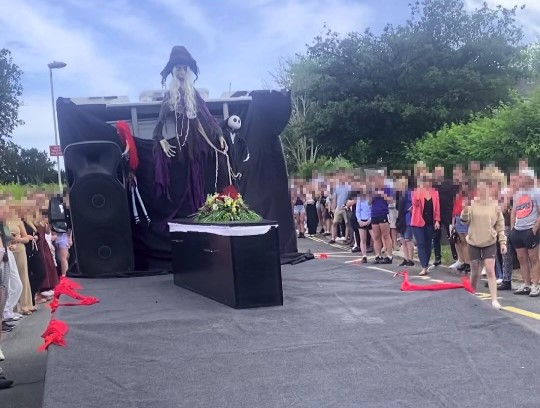 Teen stuns prom crowd by arriving in a coffin to confront bullies, making dramatic entrance with undertaker dad to prove their cruel words mean nothing.