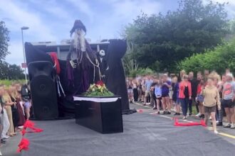 Teen stuns prom crowd by arriving in a coffin to confront bullies, making dramatic entrance with undertaker dad to prove their cruel words mean nothing.