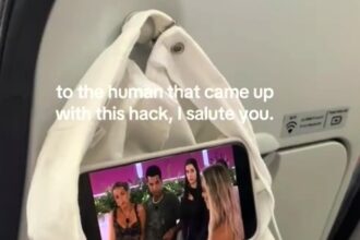 Maddison Gordon wowed passengers with a clever in-flight hack using just a hat and her phone, turning the coat hook into a mini screen holder for hands-free entertainment.