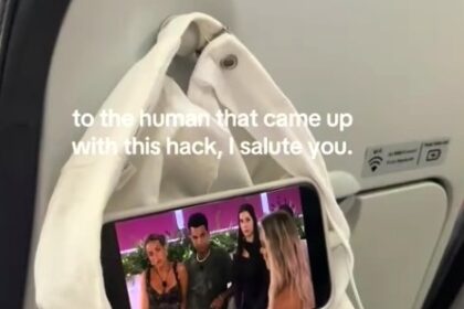 Maddison Gordon wowed passengers with a clever in-flight hack using just a hat and her phone, turning the coat hook into a mini screen holder for hands-free entertainment.