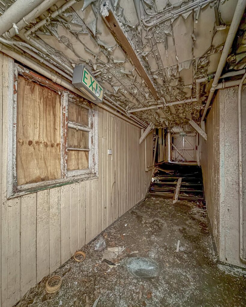 British explorer Chloe Urbex uncovers “super creepy” abandoned MOD barracks in London left to rot for 50 years - eerie photos reveal peeling walls, decayed halls and old signs.