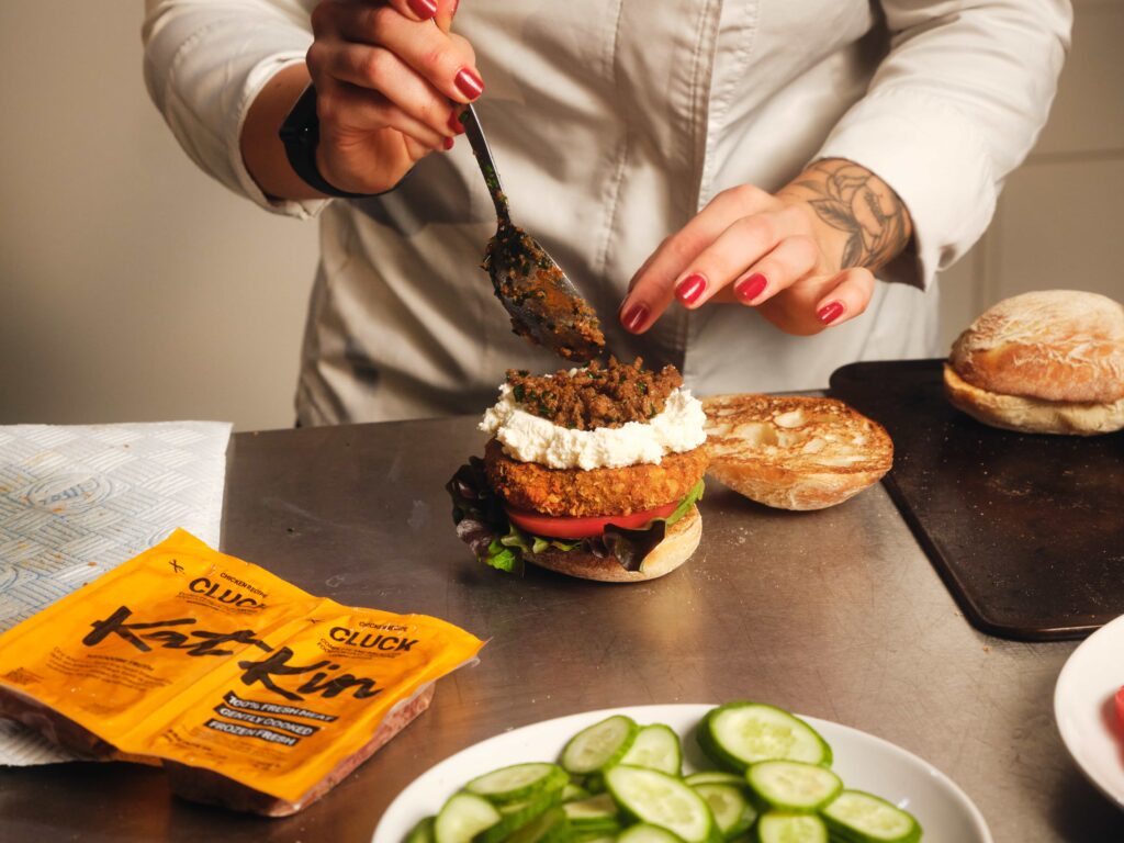 Michelin star chef creates cat food burger with KatKin to show pets deserve quality meals too - served in ciabatta with gourmet toppings and praised as delicious.