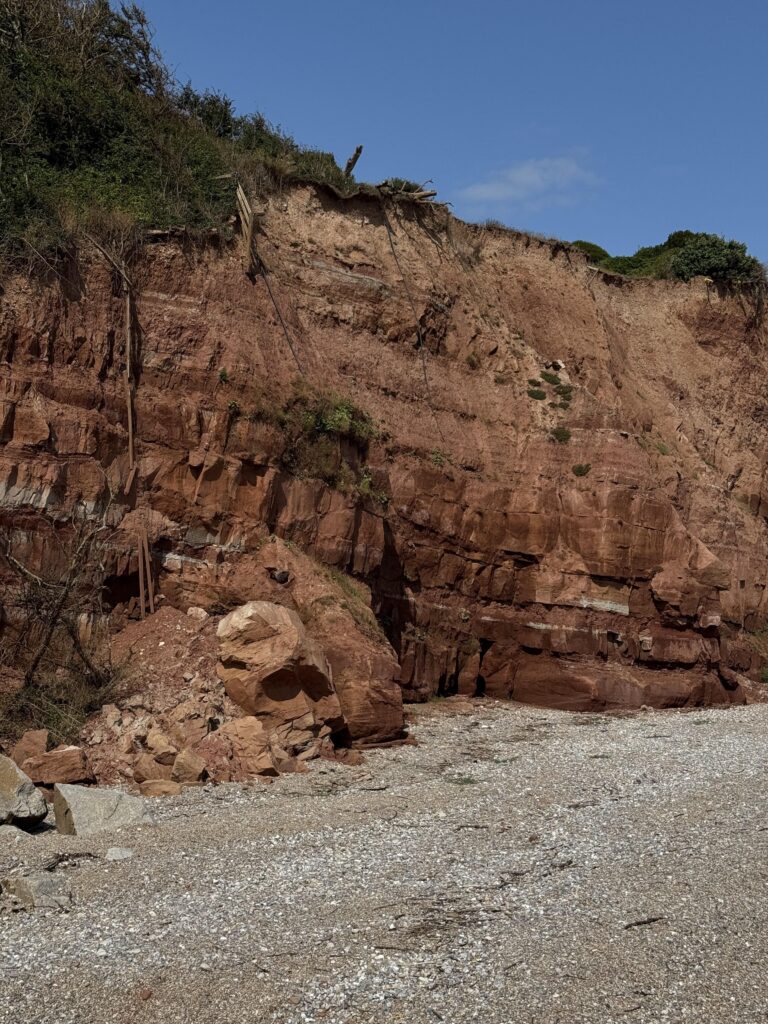 A 13ft Neanderthal-like face has mysteriously appeared on a cliff in Sidmouth, Devon. Though it looks hand-carved, the eerie formation is entirely natural.