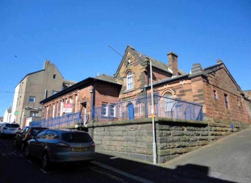Former Victorian police station in Maryport on sale for £180,000 - empty red sandstone building with cell entrances has planning permission for seven flats and homes.