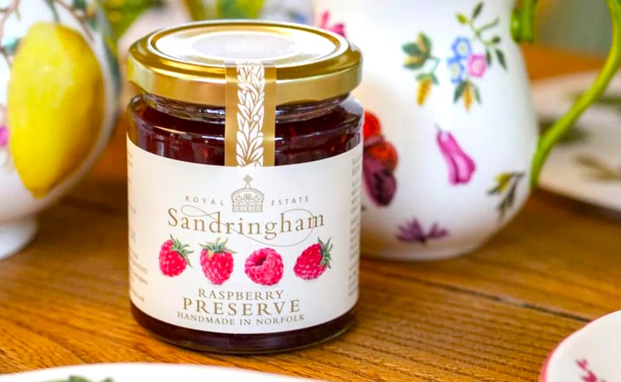 King Charles sells Sandringham raspberry jam for £4.99, less than half Meghan Markle’s price, offering a locally made, additive free preserve with rich fruity flavor.