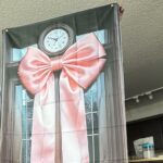 Mum left baffled after Temu baby shower order turns out to be a flat polyester sheet printed with a door and bow instead of the 3D decoration she expected for $9.63.