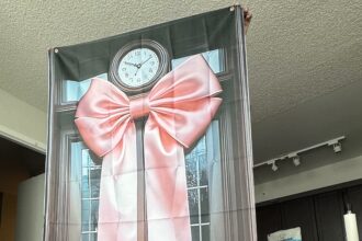 Mum left baffled after Temu baby shower order turns out to be a flat polyester sheet printed with a door and bow instead of the 3D decoration she expected for $9.63.