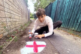 Patriotic potholes in Malmesbury get a makeover as a resident paints St George’s Crosses on them to highlight road issues and push for repairs with local support.