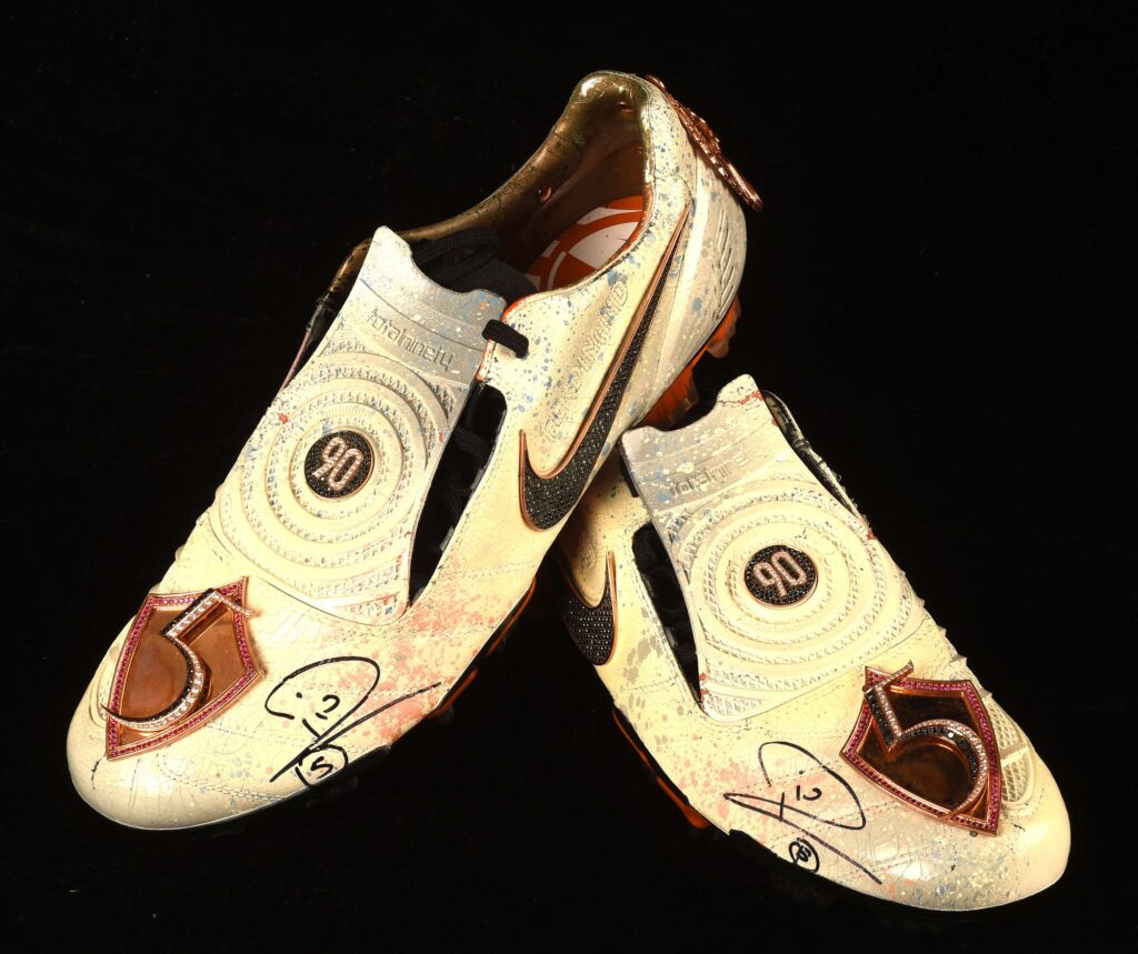 Rio Ferdinand’s diamond encrusted, gold coated Nike boots have sold for £23,400 at auction. Signed and custom designed, they’re among the world’s most unique boots.