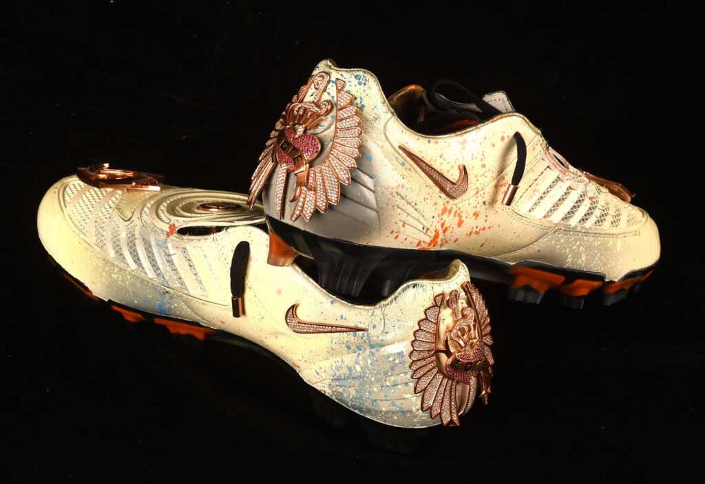Rio Ferdinand’s diamond encrusted, gold coated Nike boots have sold for £23,400 at auction. Signed and custom designed, they’re among the world’s most unique boots.