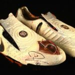 Rio Ferdinand’s diamond encrusted, gold coated Nike boots have sold for £23,400 at auction. Signed and custom designed, they’re among the world’s most unique boots.