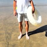 A tourist’s hilarious tanning fail left beachgoers in stitches after he revealed bright white feet against his bronzed legs in Newquay, Cornwall, with photos going viral online.