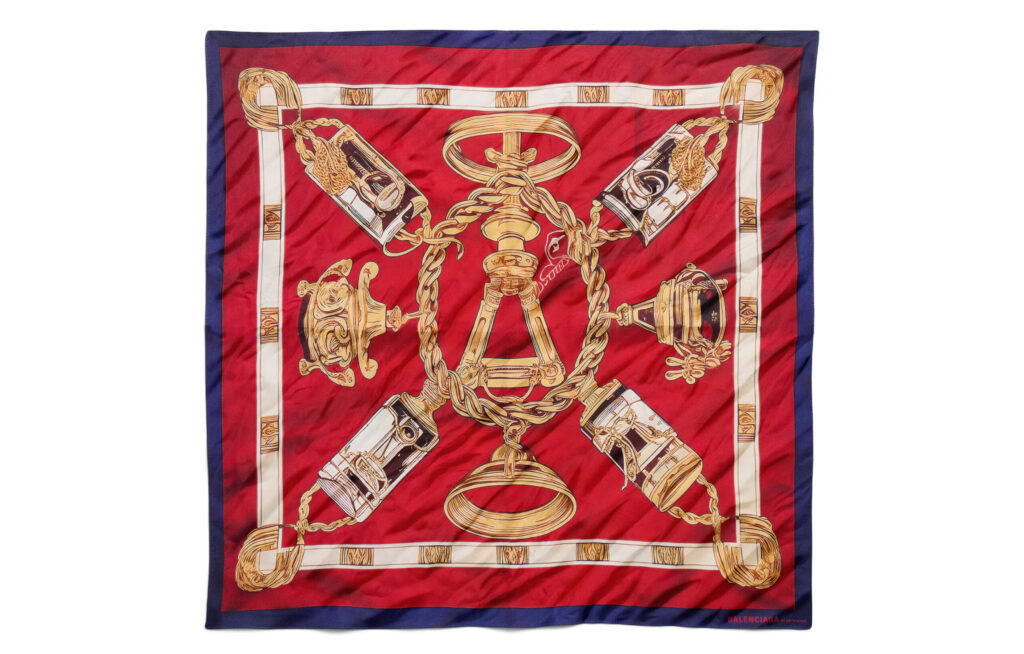 Balenciaga launches a £220 AI generated silk scarf in its Winter 25 range, sparking debate after earlier controversy over a £775 plastic style tote bag.