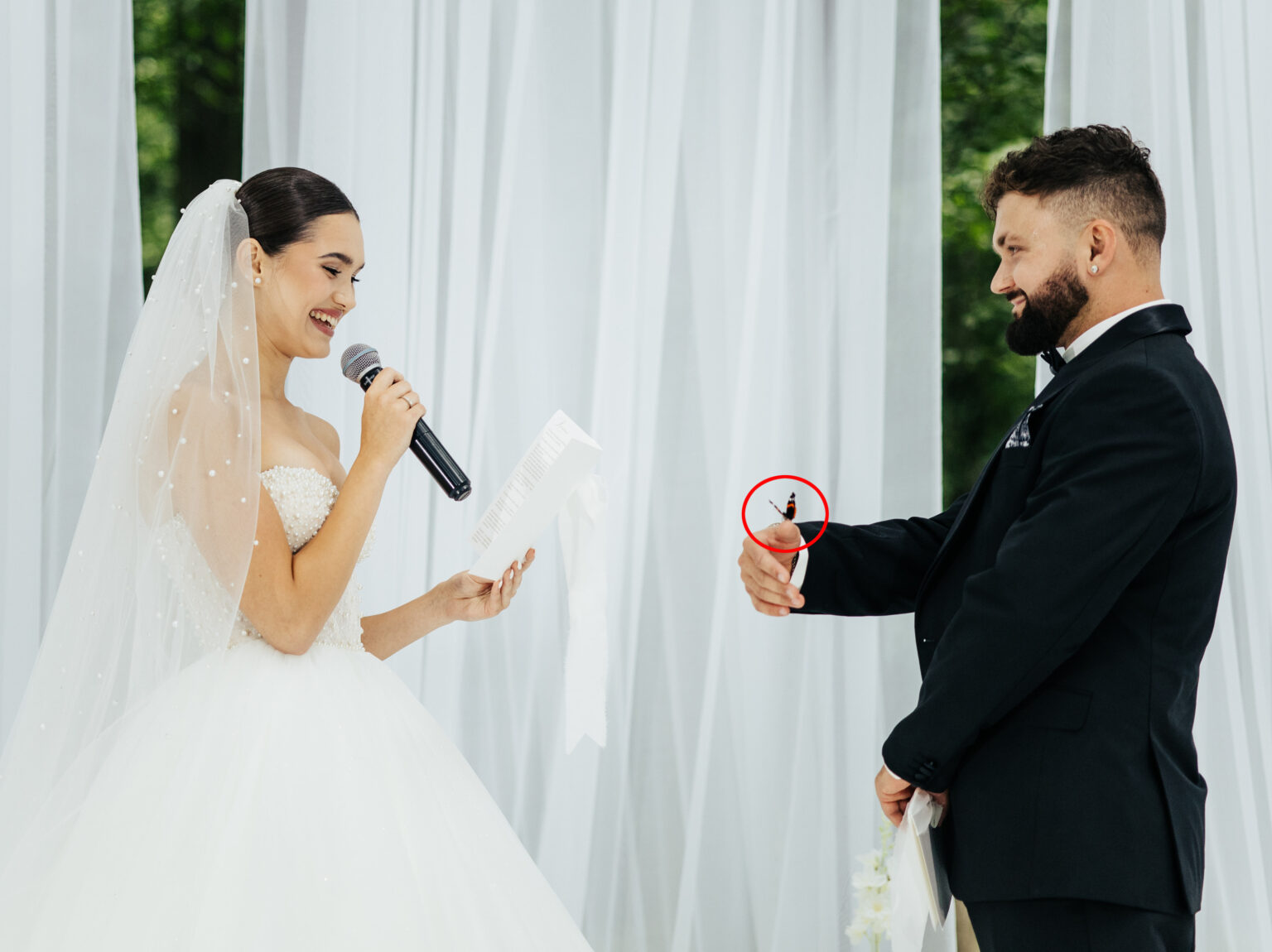 A couple’s wedding vows turned magical when a butterfly landed on the bride before perching on their hands and heads with guests calling it a heavenly blessing from loved ones.