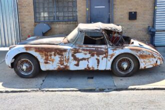 A 1959 Jaguar XK150 barn find is up for sale at £20,000 needing full restoration with matching numbers and rare factory automatic making it a classic car bargain.