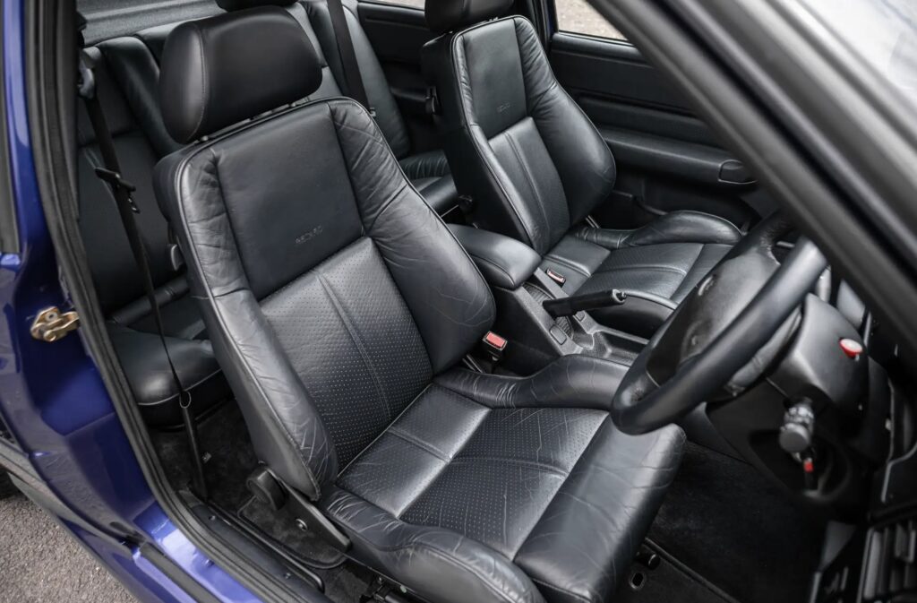 A rare 1996 Ford Escort RS Cosworth Lux with just 22,744 miles sold for £81,563. Iconic whale tail spoiler, 150mph top speed and collector quality make it a gem.
