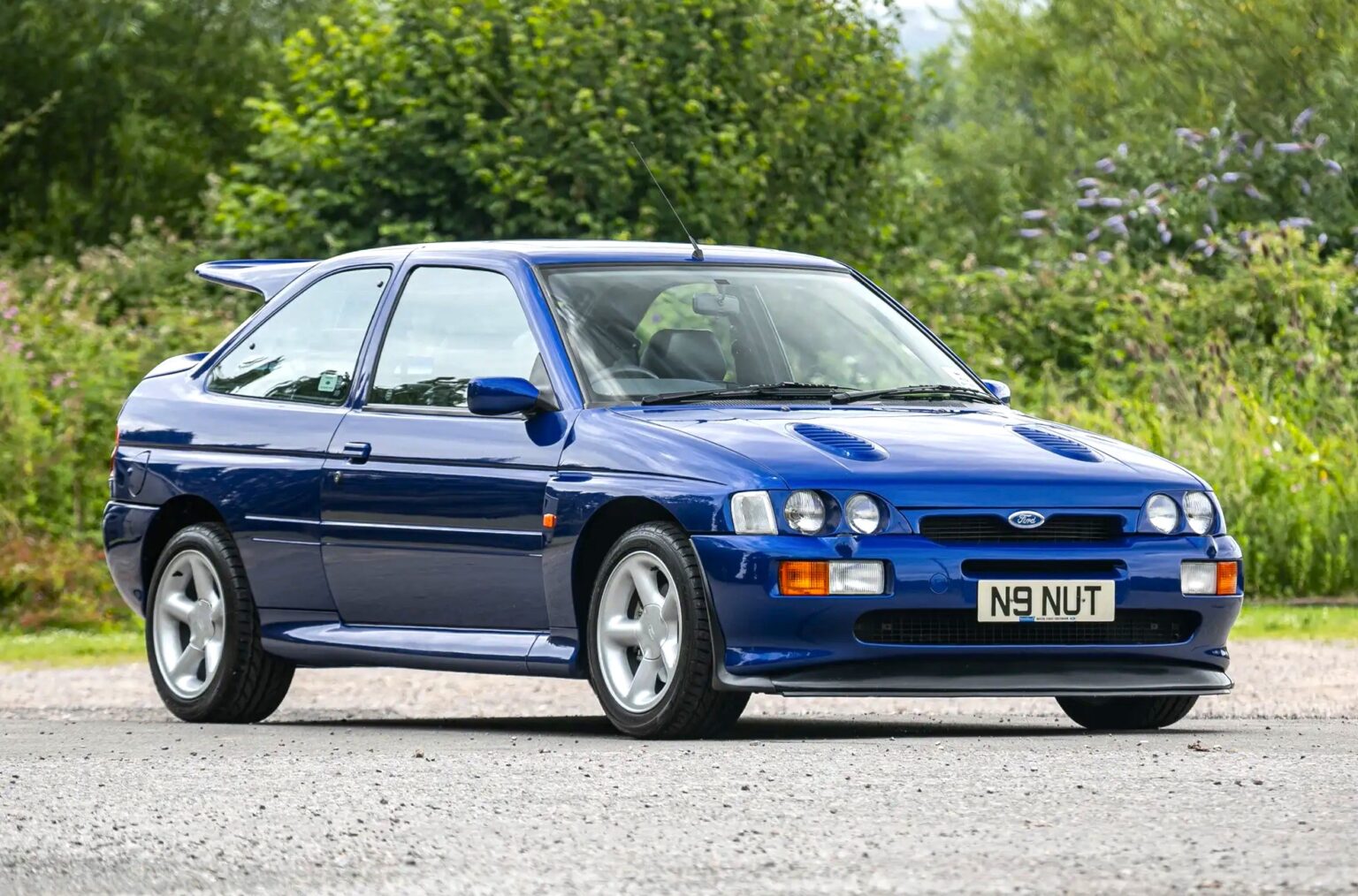 A rare 1996 Ford Escort RS Cosworth Lux with just 22,744 miles sold for £81,563. Iconic whale tail spoiler, 150mph top speed and collector quality make it a gem.