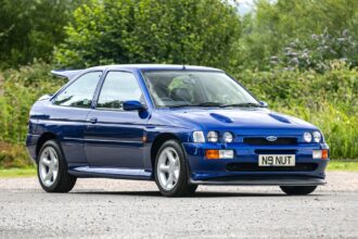 A rare 1996 Ford Escort RS Cosworth Lux with just 22,744 miles sold for £81,563. Iconic whale tail spoiler, 150mph top speed and collector quality make it a gem.