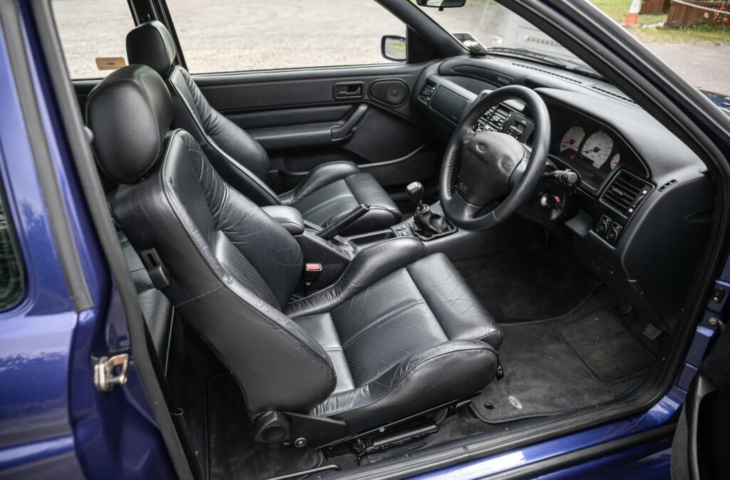 A rare 1996 Ford Escort RS Cosworth Lux with just 22,744 miles sold for £81,563. Iconic whale tail spoiler, 150mph top speed and collector quality make it a gem.