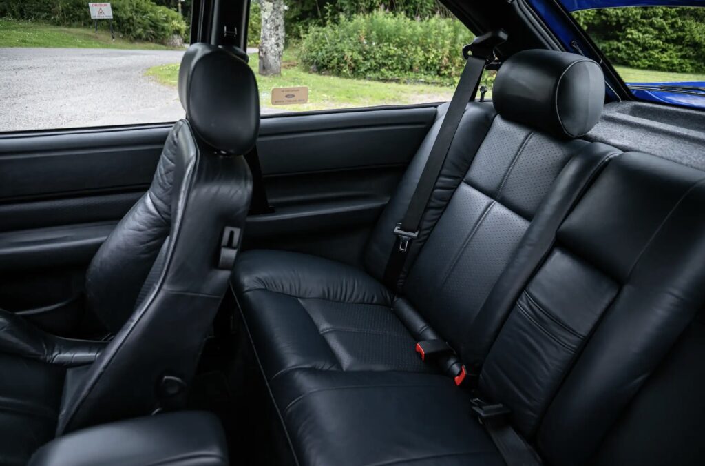 A rare 1996 Ford Escort RS Cosworth Lux with just 22,744 miles sold for £81,563. Iconic whale tail spoiler, 150mph top speed and collector quality make it a gem.