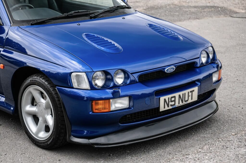 A rare 1996 Ford Escort RS Cosworth Lux with just 22,744 miles sold for £81,563. Iconic whale tail spoiler, 150mph top speed and collector quality make it a gem.