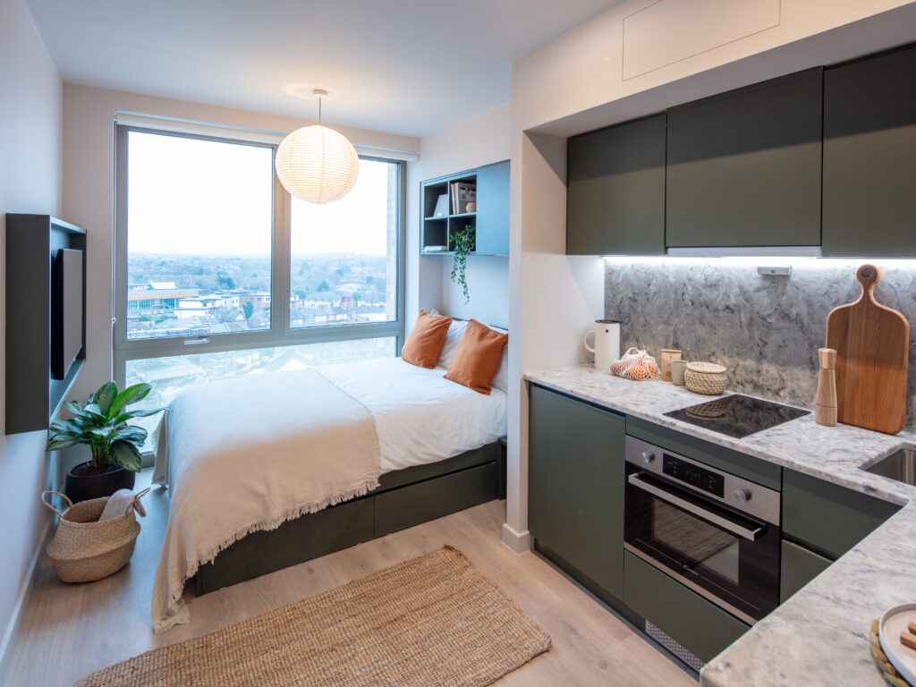 Woman saves £500 a month by swapping tiny rental for co living with 200 housemates in London - private studio plus gym cinema and shared spaces all included in rent.
