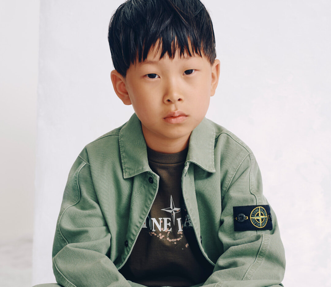 Stone Island mocked for launching £245 over-shirt for kids in new autumn range. Branded youth fashion sparks jokes linking it to football hooligan culture and films.