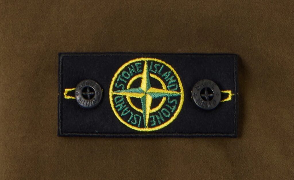 Stone Island mocked for launching £245 over-shirt for kids in new autumn range. Branded youth fashion sparks jokes linking it to football hooligan culture and films.