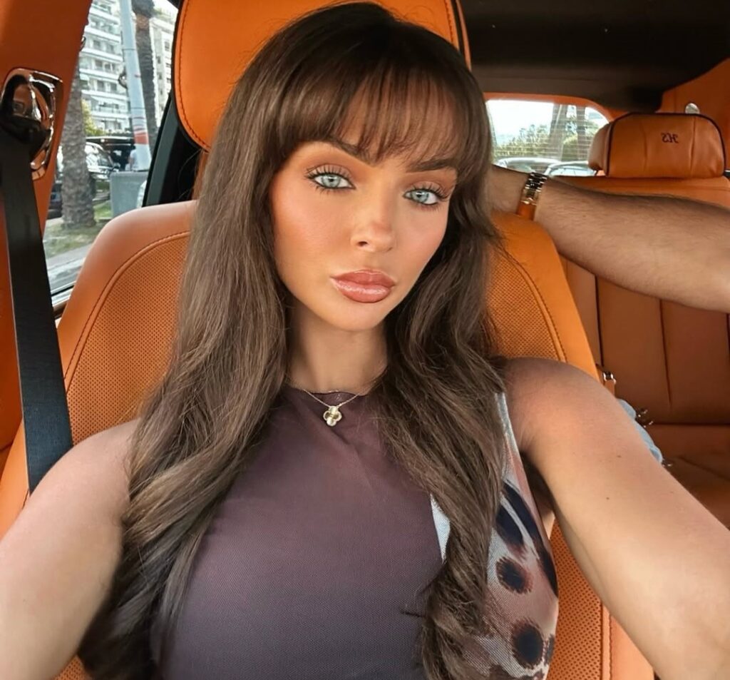 Love Island star Kady McDermott squeals as Hyde Park parakeets swarm her - one cheeky green bird even tries to peck her ear during surprise encounter in London.