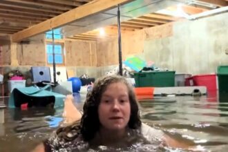 Mum films herself swimming in flooded basement after storm devastates home in Quincy Illinois - viral TikTok shows her coping with loss as family faces huge cleanup.