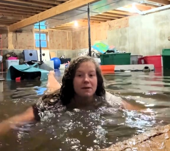 Mum films herself swimming in flooded basement after storm devastates home in Quincy Illinois - viral TikTok shows her coping with loss as family faces huge cleanup.