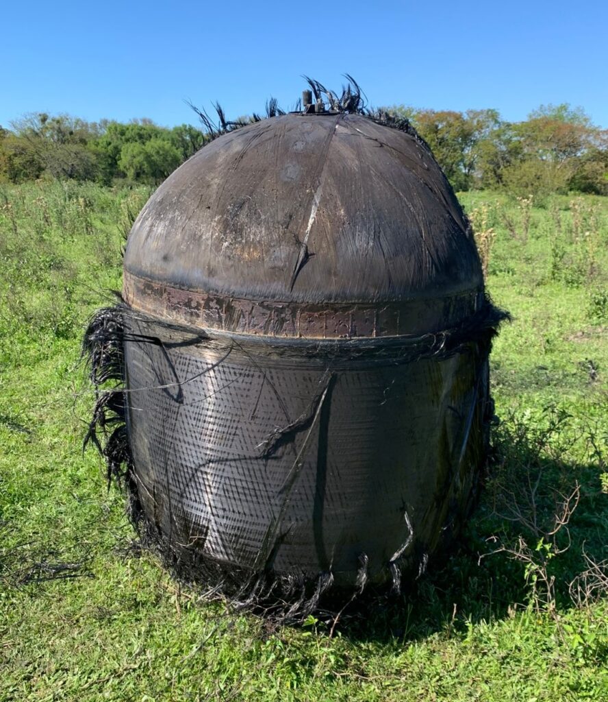 A bizarre hairy cylinder fell from the sky onto a farm in Argentina sparking speculation it could be space junk as baffled officials investigate the mysterious object.