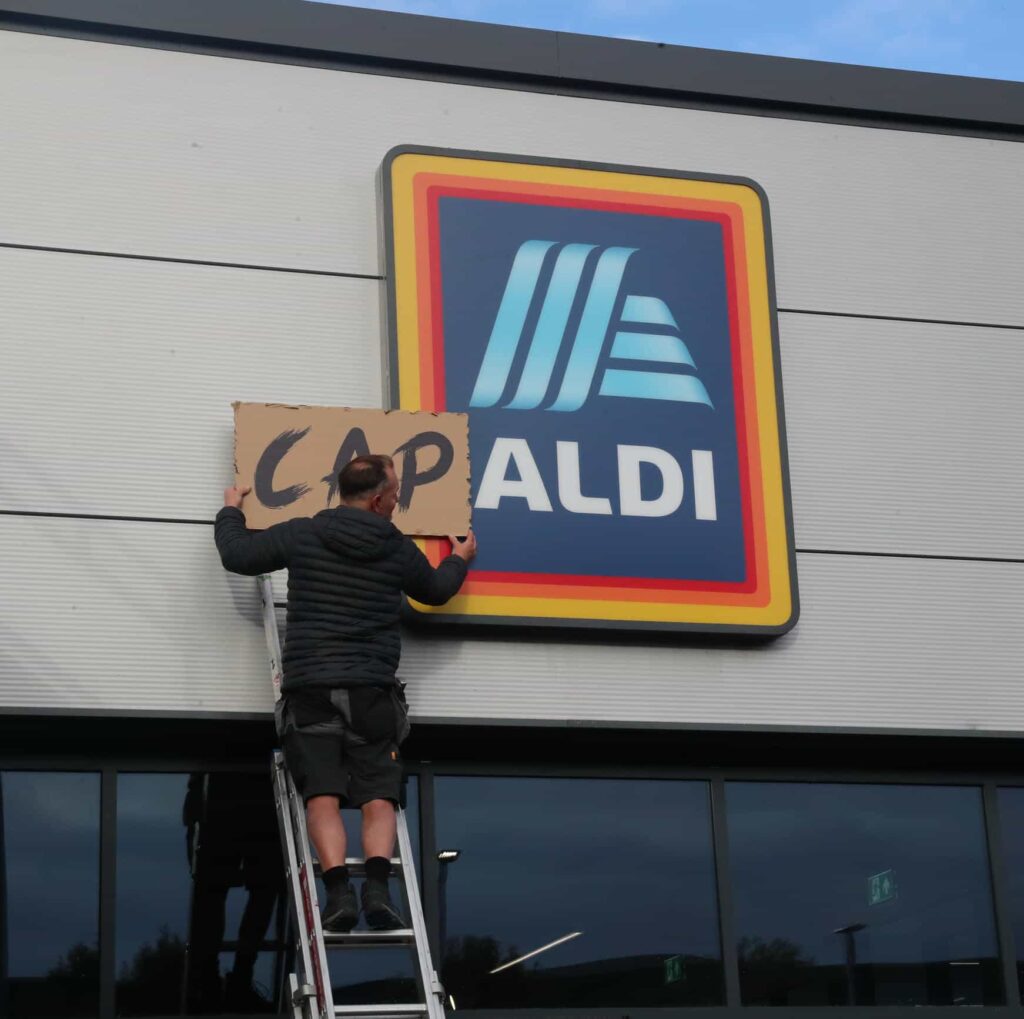 Lewis Capaldi surprises fans by performing his new single on the roof of an Aldi supermarket in Nottingham, leaving shoppers stunned by the unexpected rooftop gig.
