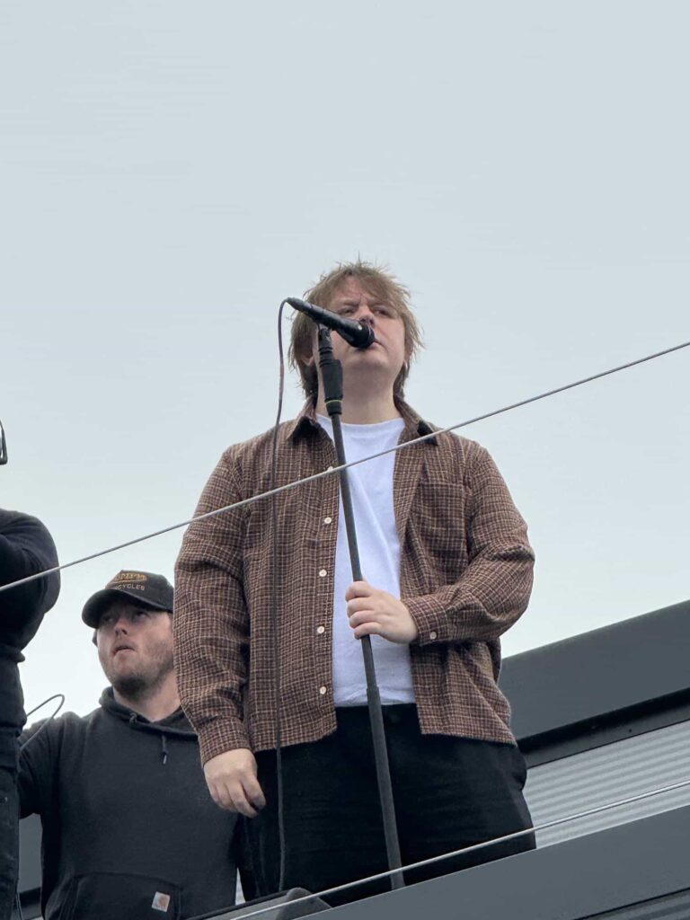 Lewis Capaldi surprises fans by performing his new single on the roof of an Aldi supermarket in Nottingham, leaving shoppers stunned by the unexpected rooftop gig.