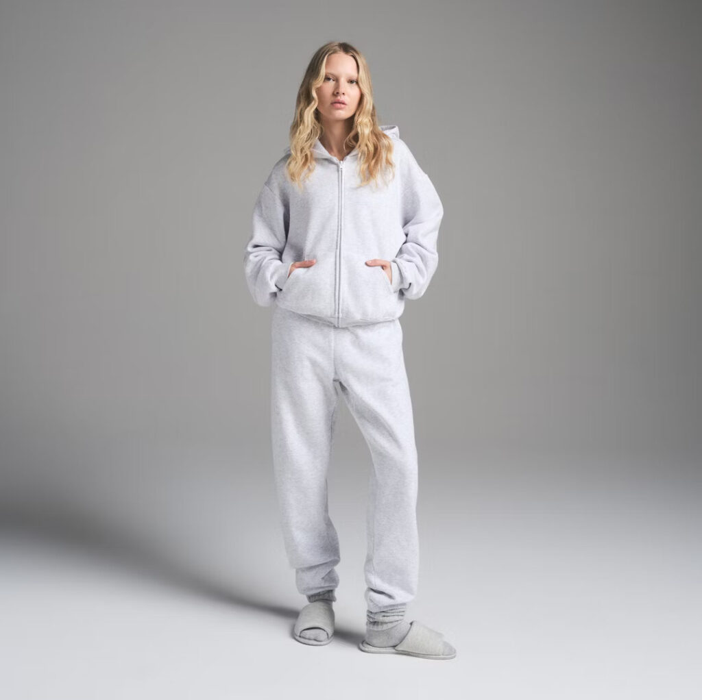 Rapper Sophie Aspin slams Kim Kardashian’s £94 SKIMS joggers saying they give her a granny bottom as fans joke the baggy fit is made for people with BBLs.