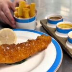 Tom Kerridge faces backlash after charging £35 for haddock and chips with posh sauces at his London restaurant, sparking outrage from fishermen and diners online.
