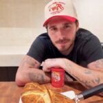 Brooklyn Beckham faced backlash after using Bisto gravy on his luxury beef wellington, with fans calling it a “ruined masterpiece” while others defended his down-to-earth choice.