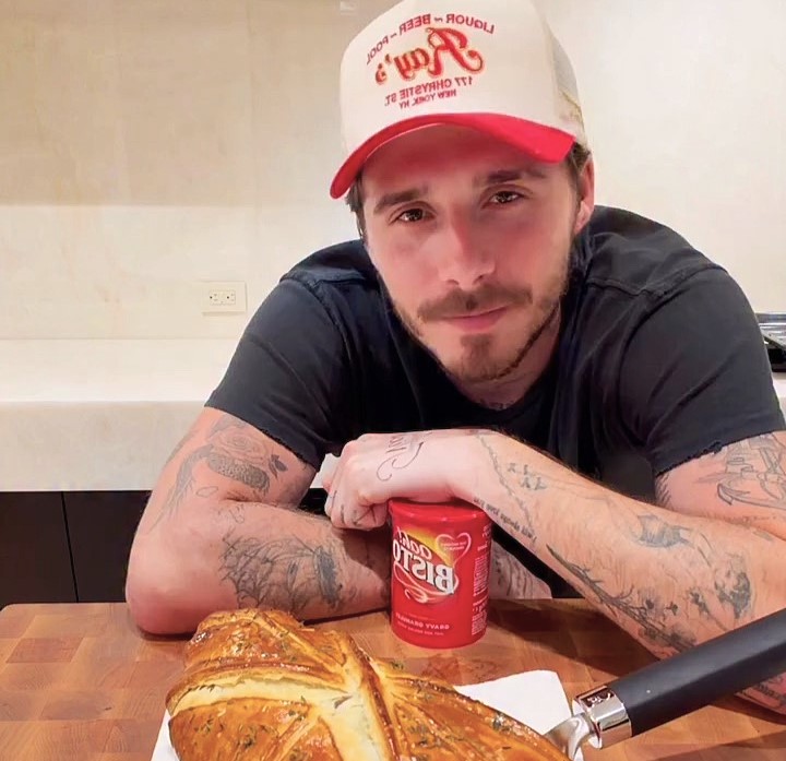 Brooklyn Beckham faced backlash after using Bisto gravy on his luxury beef wellington, with fans calling it a “ruined masterpiece” while others defended his down-to-earth choice.