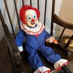 Ghost hunters Lee Steer and Sarah Carter claim their haunted clown doll “Bozo” rips off duvets, moves objects, and laughs on camera, terrifying owners and visitors alike.
