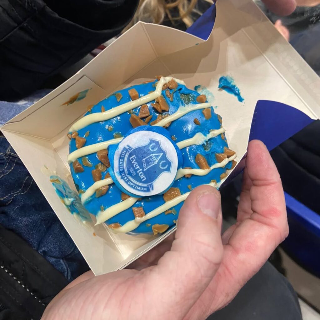 Everton fans slam new Hill Dickinson Stadium prices as iconic blue toffee doughnuts jump from £2.50 at Goodison Park to £6.50 sparking outrage over matchday costs.