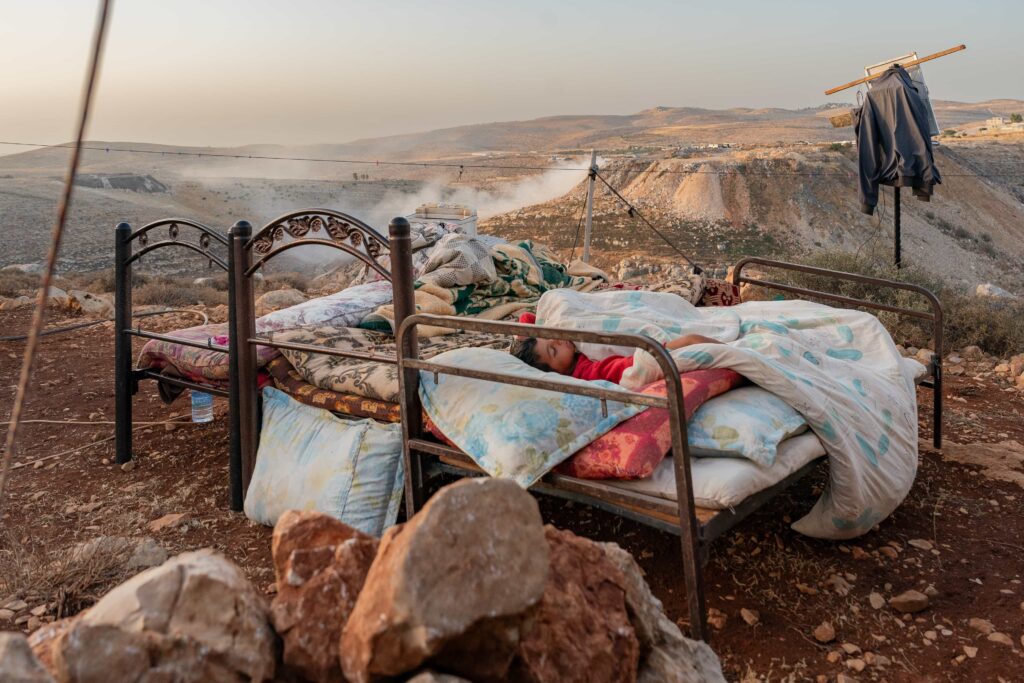 Palestinian photographer Ali Jadallah wins Siena International Photo Awards 2025 with Leaving Home a powerful image of families fleeing rubble in Gaza after an airstrike.