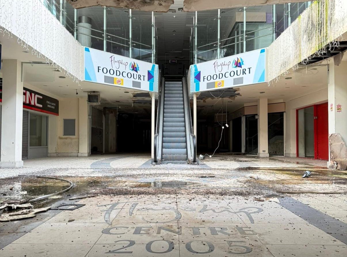 An urban explorer has revealed the eerie inside of a crumbling abandoned shopping mall in Bangor, Northern Ireland, left to rot with moss-covered floors, shattered windows and a collapsing roof.