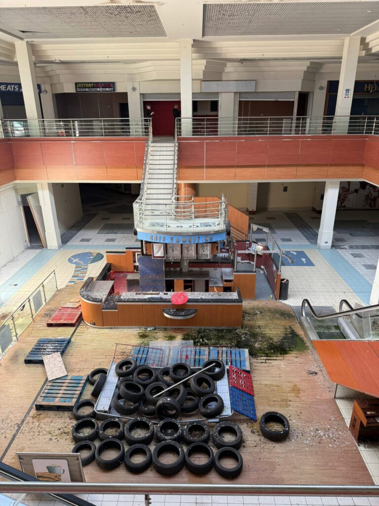 An urban explorer has revealed the eerie inside of a crumbling abandoned shopping mall in Bangor, Northern Ireland, left to rot with moss-covered floors, shattered windows and a collapsing roof.