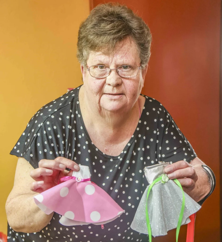 South African woman Marie Odendaal lives with 100 dolls and makes 400 outfits a week treating them as her babies as she talks to them proudly and supports her daughter through her doll clothing business.