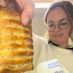 American expat Stacey Gaw tries Greggs for the first time but sparks backlash for heating the food and serving it on a plate as she reviews sausage rolls melts and festive favourites while adapting to UK culture.