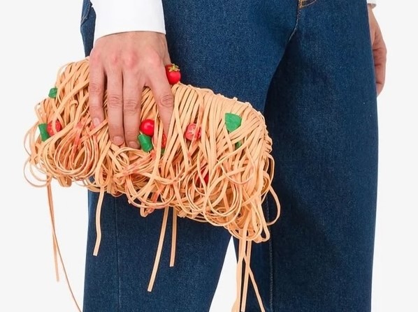 model holiding Moschinos spaghetti bag.