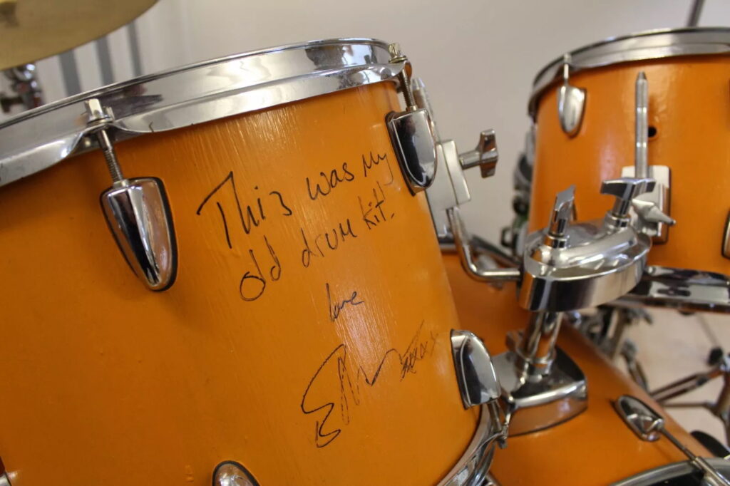 Ed Sheeran’s old orange drum kit, played and painted by him as a teen, is up for sale on eBay for £5,000 after being donated to charity and signed by the superstar.