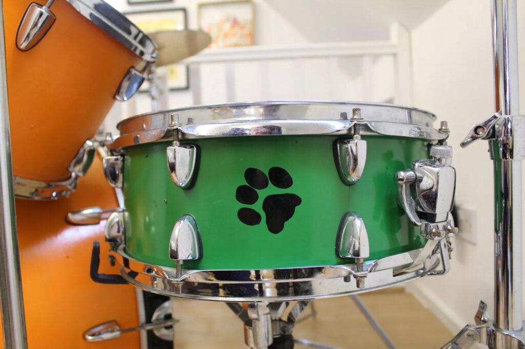 Ed Sheeran’s old orange drum kit, played and painted by him as a teen, is up for sale on eBay for £5,000 after being donated to charity and signed by the superstar.