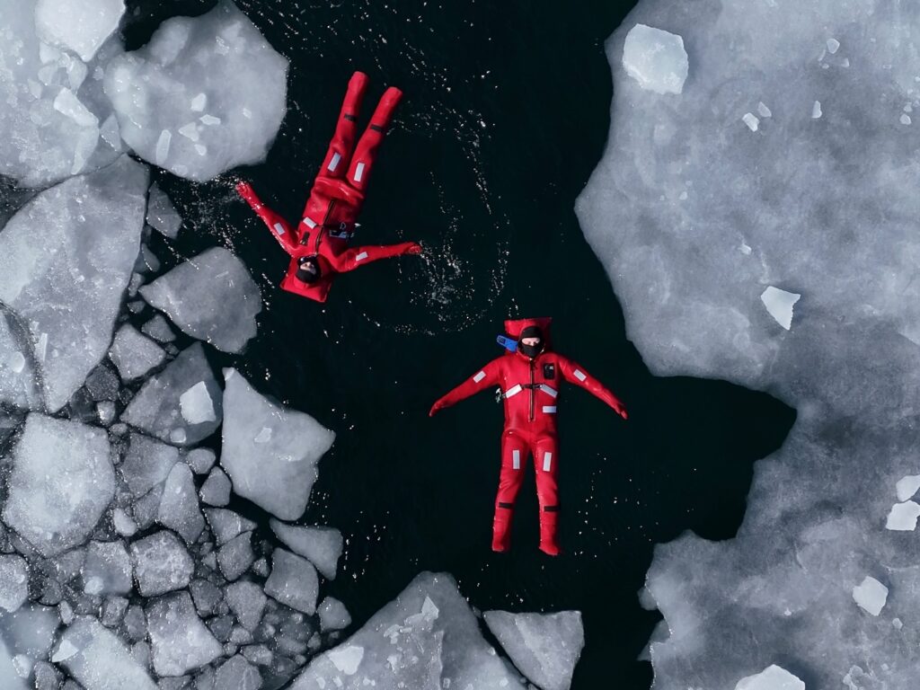 A new extreme winter trend called ice floating is going viral - thrill-seekers in red suits dive into freezing Arctic waters in Russia for the ultimate icy adventure.